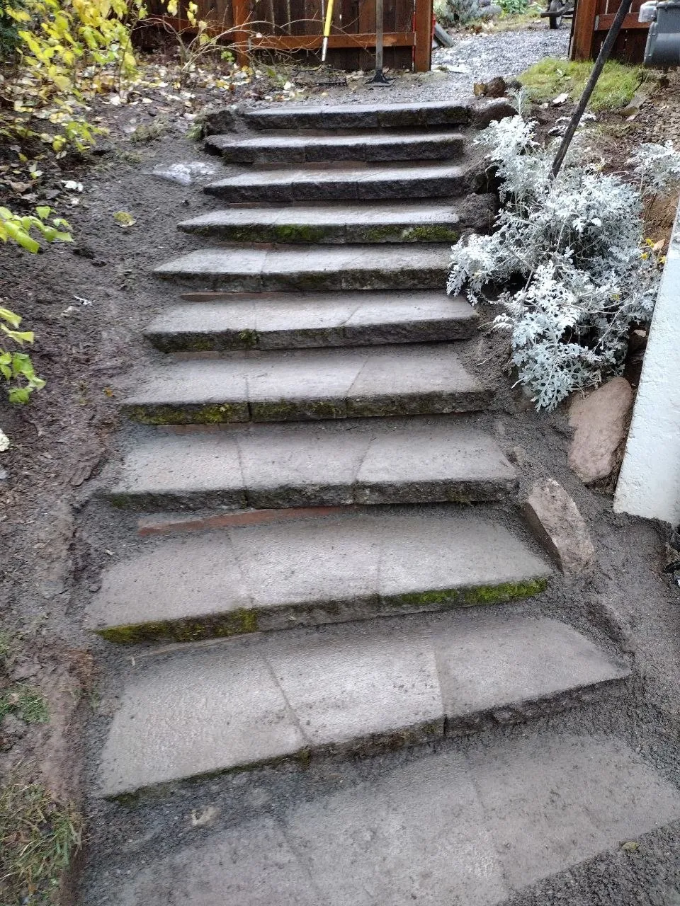A full flight of set treads climbing to the gate, with the bank graded either side.